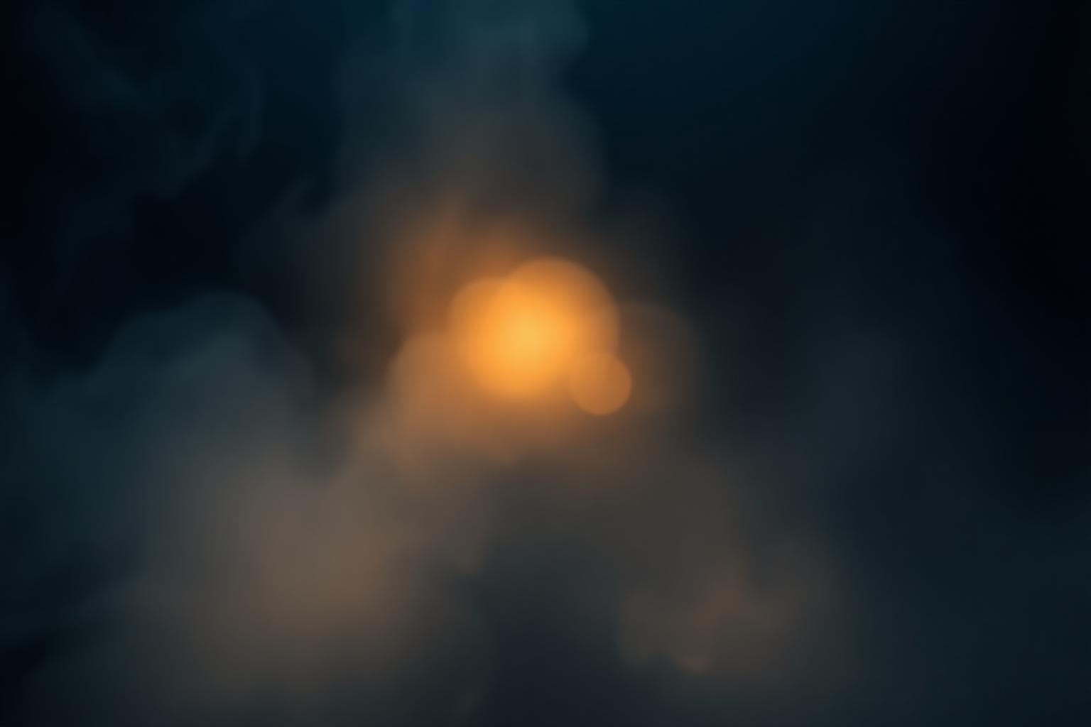 Ethereal golden light through deep navy mist